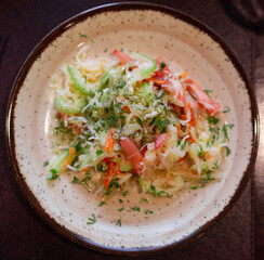 Plate with fresh vegetable salad of tomato, cucumber and celery close up