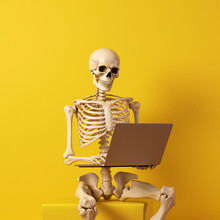 Skeleton Using A Laptop On A Yellow Background. Generative AI.