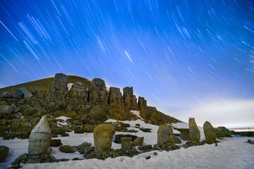 god statues and mount nemrut on mount nemrut in adıyaman. winter is a snowy day. night star exposure