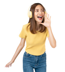 Young asian woman listening music with yellow headphones and shouting open mouth isolated on white background studio.