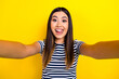 Photo of excited cheerful positive lady wear trendy clothes make selfie showing bright toothy smile isolated on yellow color background