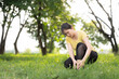 © Worranan - Asian woman holding her injured ankle at the park