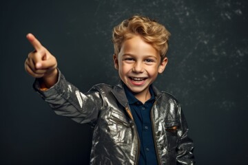 Wall Mural - Medium shot portrait photography of a joyful boy in his 30s pointing with two hands and fingers to the side against a metallic silver background. With generative AI technology