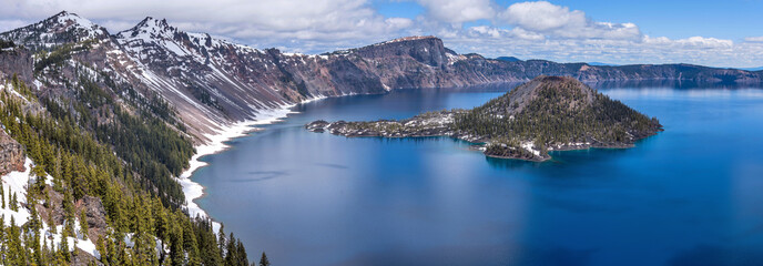 Wall Mural - Wizard Island - A Spring day panoramic view of Wizard Island, surrounded by deep blue water of Crater Lake and rugged lake rim. Crater Lake National Park, Oregon, USA.