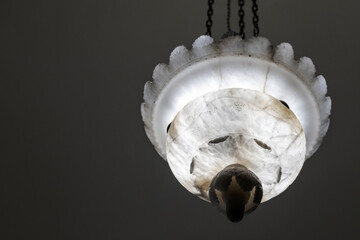 Wall Mural - Vintage chandelier with white carved stone lamp shade, close up