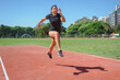 © SETO fotografias - young latin woman runner training doing long jumps