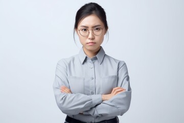 Wall Mural - Portrait of young Asian businesswoman standing with arms crossed isolated on white background. Generative AI