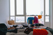 © Sevendeman - Cluttered and untidy apartment bed room full of colorful clothes on everywhere.