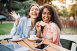 © Prostock-studio - Easy Payments. Two Women Showing Credit Card While Sitting In Cafe Outdoors