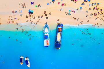Wall Mural - A drone view of the beach and the sea. People on vacation. Vacation and holidays. Summer time for sea travel. The sea bay. Photo for background and wallpaper. Mediterranean Sea.
