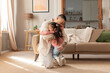 © Prostock-studio - Asian father and daughter embracing and cuddling at living room