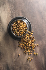 Wall Mural - Dry kibble pet food. Dog or cat food on old table. Top view.