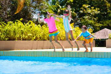 Wall Mural - Kids jump into swimming pool. Summer water fun.