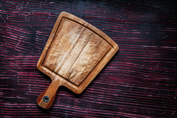 Wall Mural - Old cutting board on dark  table. View from above. copy space.