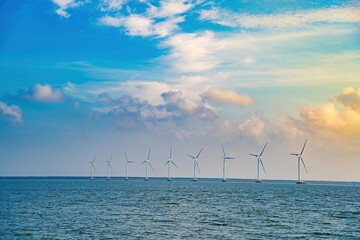 Panoramic view of wind farm at sea, with high wind turbines for generation electricity with copy space at Tra Vinh, Viet Nam. Green energy concept. Eco concpept