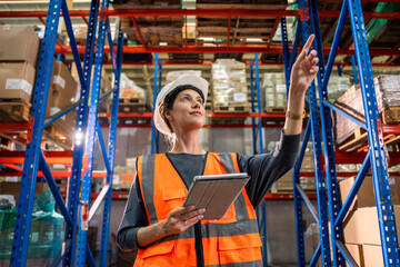 Wall Mural - Caucasian young woman industrial worker working in manufacturing plant. 