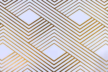 Shiny gold geometric lines on white paper top down view