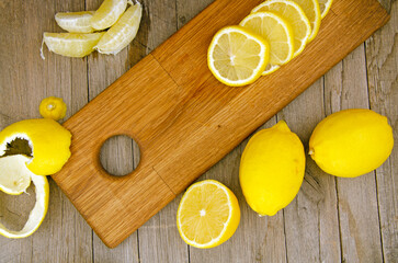 Wall Mural - Lemon slices and segments on wooden board