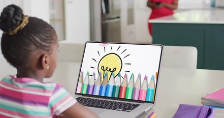 Wall Mural - African american girl using laptop for video call, with coloured pencils and light bulb on screen