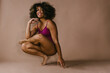 © Cavan Images - Female black dancer poses on foot with big smile and curly hair