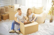 © lenets_tan - Happy young couple unpacking or packing boxes and moving into a new home