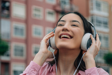 Sticker - smiling girl on the street with earphone