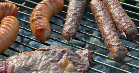 Poster - various grilled sausages and meat on burning charcoal grill