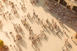 Top view of the city square with a crowd of people walking around. Crowd small figures of unrecognizable people walking in town square, city life concept. Generative AI