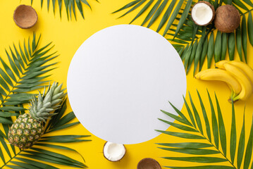 Wall Mural - Yearning for tropical bliss. Overhead view of green palm leaves, and luscious tropical fruits on a vivid yellow backdrop with ample circle for text or promotional messaging