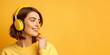 Beautiful young, brunette  woman listening to music. Isolated on yellow background. Vibrant banner, copy space.