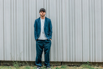 Wall Mural - young man or student in the street with wall in background