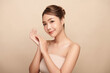 © kitthanes  - Beautiful young asian woman with clean fresh skin on beige background, Face care, Facial treatment, Cosmetology, beauty and spa, Asian women portrait.