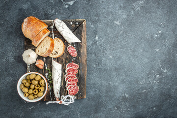 Wall Mural - Slices of delicious spanish sausage fuet on a dark background. banner, menu, recipe place for text, top view