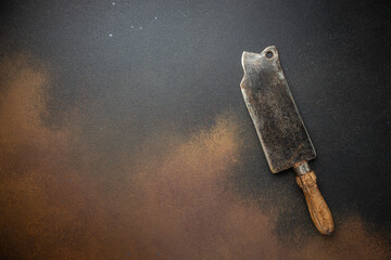 Poster - vintage kitchenware kitchen utensils: Meat Fork and Butcher Cleaver and herbs knife, ingredients for grilling meat steak on a dark background. place for text, top view