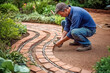 A man lays out a path in the garden from clinker tiles. Generative AI