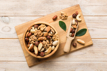 Wall Mural - mixed nuts in bowl. Mix of various nuts on colored background. pistachios, cashews, walnuts, hazelnuts, peanuts and brazil nuts
