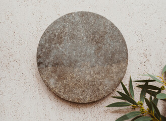 Wall Mural - Marble gray round podium and green eucalyptus branch on beige texture background