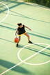 © ADDICTIVE STOCK - Brutal woman dribbling basketball ball on court