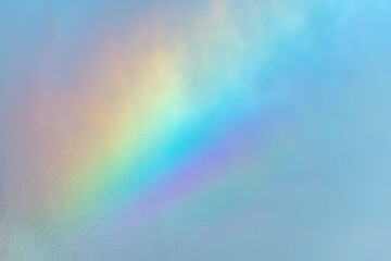 Rainbow colors in the stream of water from an agricultural sprinkler.