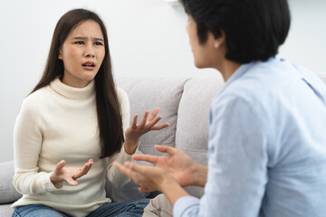 Wall Mural - Family problems, Asian women cover her face and sit separately from husband feel disappointed after quarrels at home.