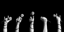 Microphone In Singer Hand In Various Poses. Black And White. Singing And Performer Concept