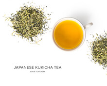 Creative Layout Made Of Cup Of Tea, Kukicha Green Tea On White Background.Flat Lay. Food Concept.