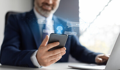 Aufkleber - Cropped businessman sitting at workplace, using chat bot on phone