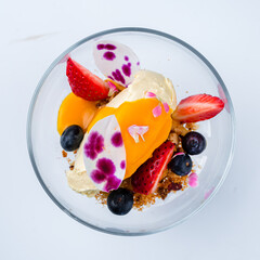 Canvas Print - Dessert cream cheese with mango sauce, strawberries, blueberries and crushed biscuits.