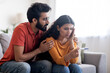 © Prostock-studio - Upset indian couple with negative pregnancy test sitting on couch at home