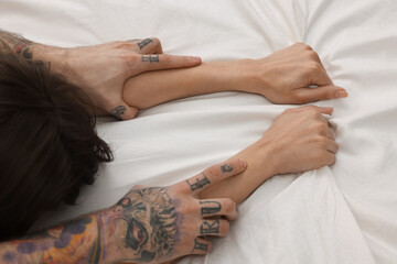 Wall Mural - passionate couple having sex on bed, closeup of hands