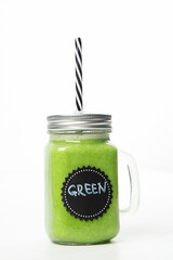 Wall Mural - Healthy green smoothie  in a jar mug  on white background