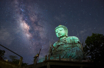 Wall Mural - Daibutsu or 'Giant Buddha' is a Japanese term often used informally for a large statue of Buddha, Giant Buddha with milky way in sky at night, Mae Tha District, Lampang Province.