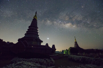 Wall Mural - spectacular milky way over a sacred temple at doi inthanon national park, chiang mai, thailand.