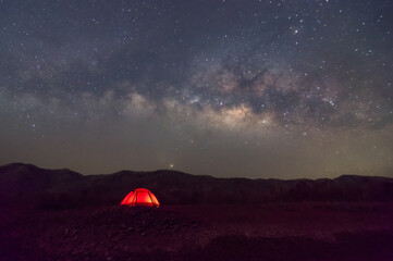 Wall Mural - red tent in reservoir under milky way galaxy with stars and space dust in the universe, long speed e